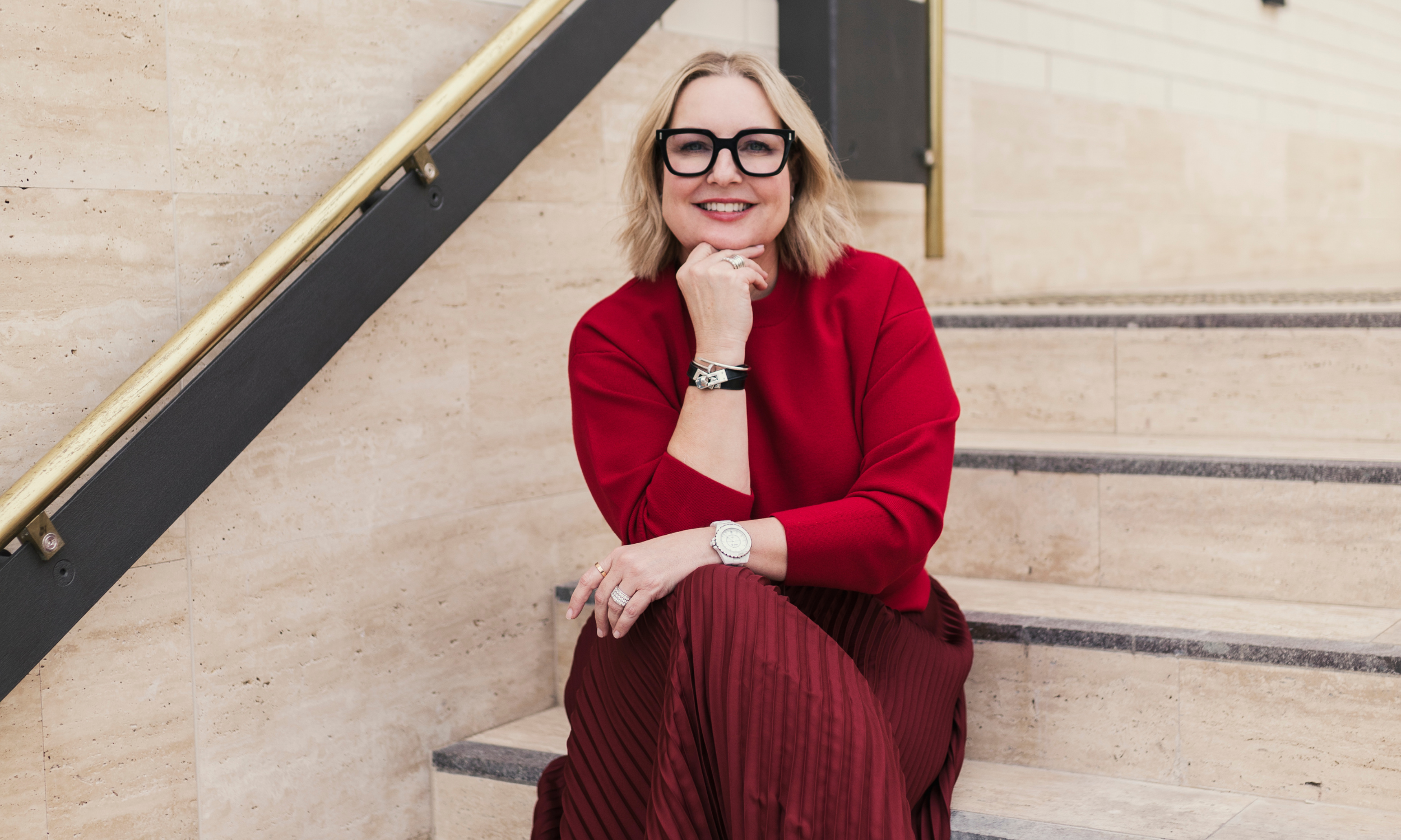 Picture of Dr Michelle Squires from Qr8Mediskin sitting on steps for Ultra Violette's blog post: Sunscreen before or after moisturiser?