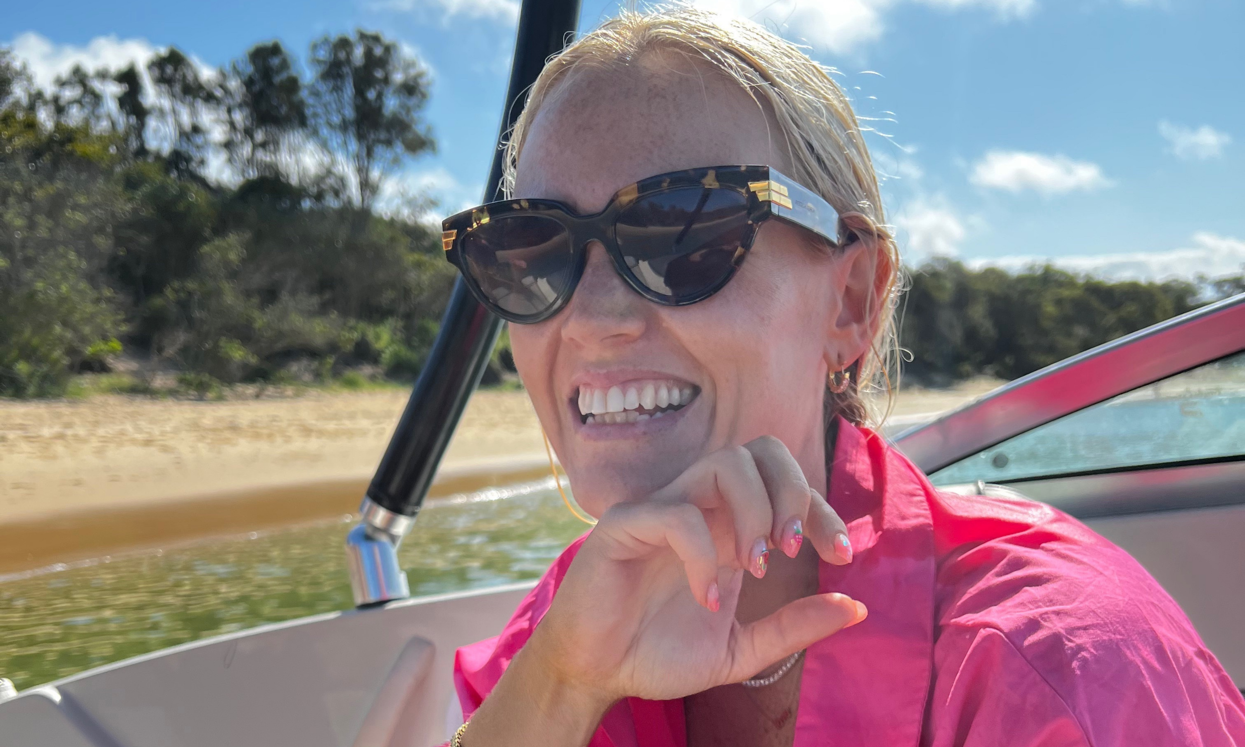 Ava Matthews sitting on a boat wearing Ultra Violette.