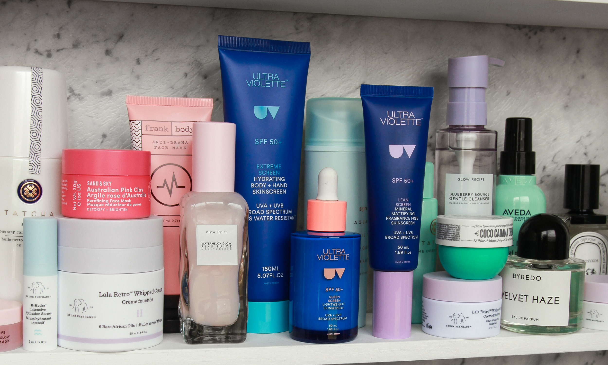 This Skincare and SPF Combo Is God Tier blog. Picture of Ultra Violette products in a beauty cabinet with other beauty products.