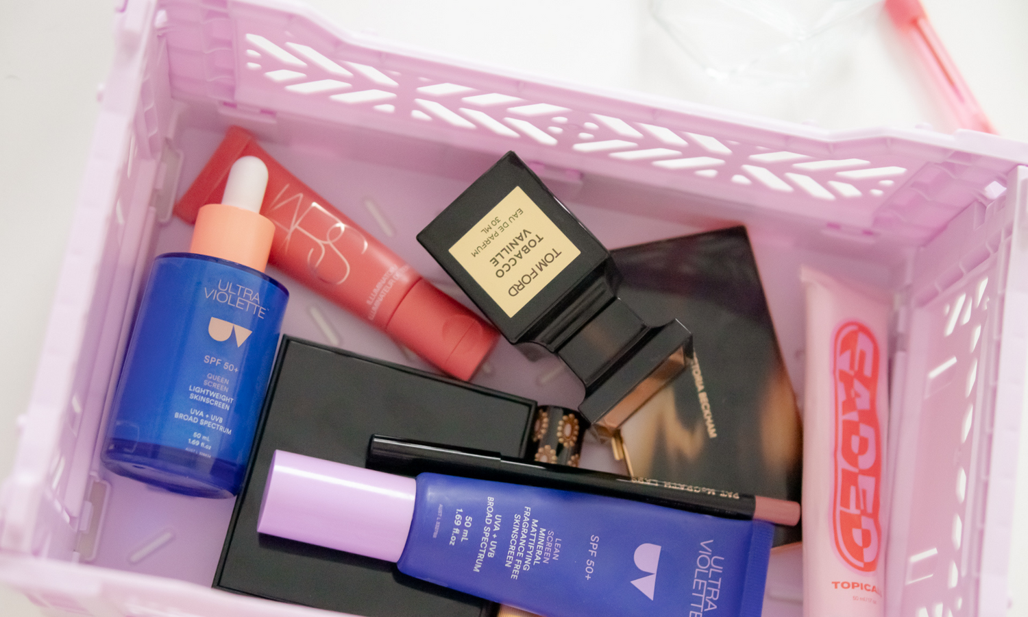 Ultra Violette Lean Screen and Queen Screen in a beauty basket alongside other beauty products.